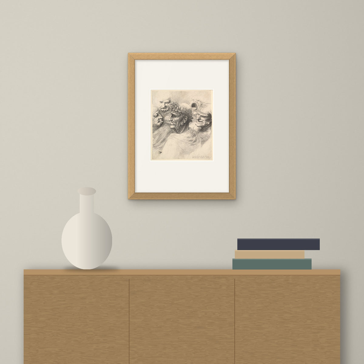 Five Grotesque Heads – framed on a wall above a sideboard