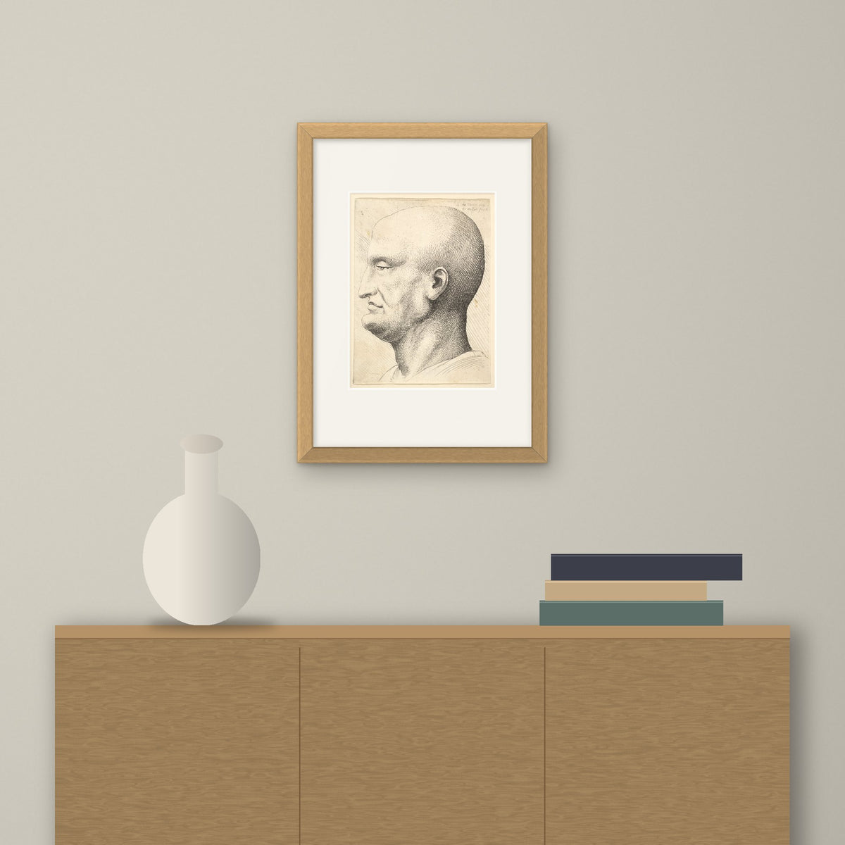 Head of a Bald Man – framed on a wall above a sideboard