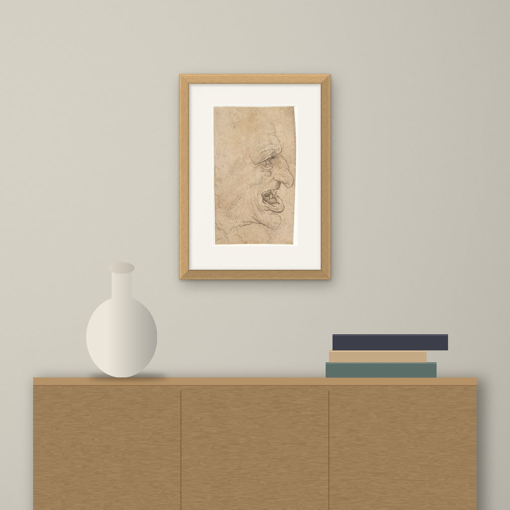 Head of a Grotesque Man – framed on a wall above a sideboard